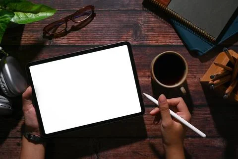 Above view of man using digital tablet on wooden table. Blank for your Stock Photos