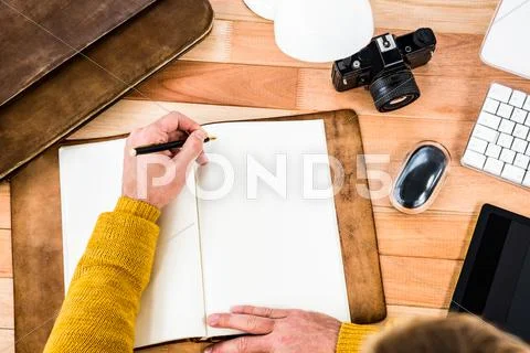 Above view of man writing on notebook Stock Photos