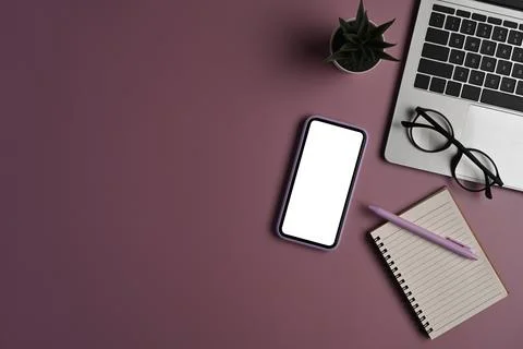 Above view mobile phone, computer laptop, notebook and glasses on purple 写真素材