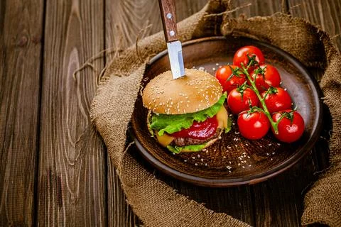 From above view of rustic serving classic beef burger with knife on wooden table Stock Photos