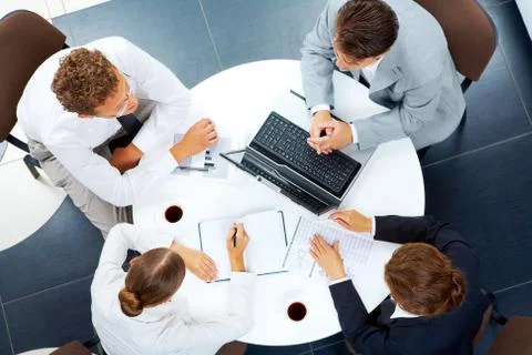 Above view of several business people planning work at round table Stock Photos
