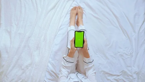 Above view woman using mobile sits in bedroom Stock Footage 120768957