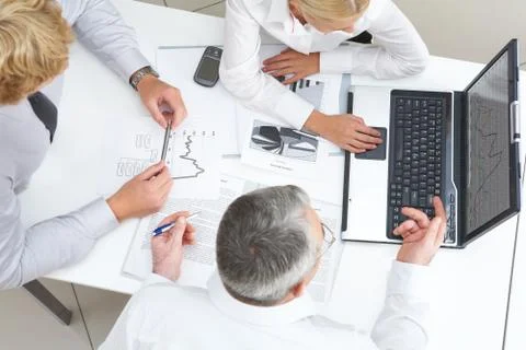 Above view of workteam discussing computer project at meeting Stock Photos