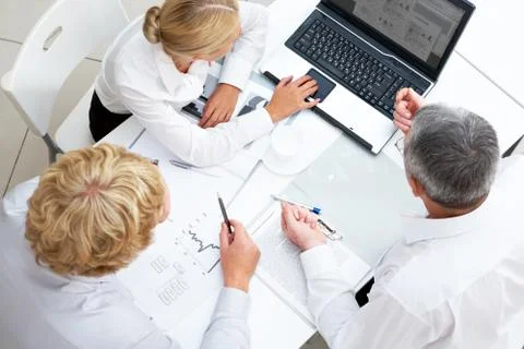 Above view of workteam discussing computer project at meeting Stock Photos