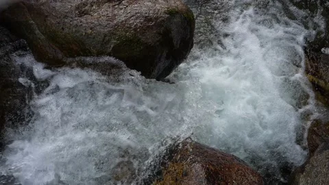 Above waterfall in mountain stream slow motion push in of clean flowing water Stock Footage 156047454