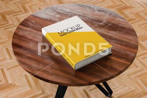 From above of white mock up book placed on round wooden table PSD Template