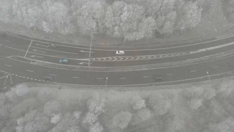 Above Winter Road With Traffic, Surrounded by Forest, Sideway Aerial Stock Footage 146895102