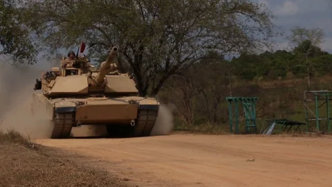 Abrams battle tank tracking through Camp Ban Chan Krem, Thailand Stock-Footage 104601850