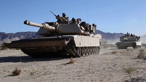 Abrams M1A1 tanks tracking over sand Stock Footage 84790061