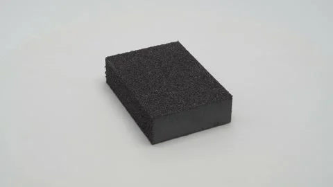 Abrasive sponge on a white background. Видео 265431964
