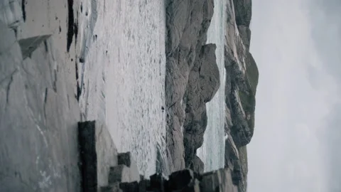 Abrupt coastline on a winter windy and rainy day. Video stock 169748906