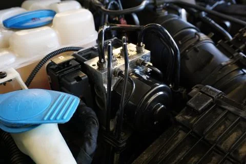 ABS unit installed in the engine compartment of the car. 스톡 사진