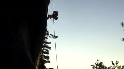 Abseiling off the route at sunset in the Siberian's rocks Stockbeeldmateriaal 69772061