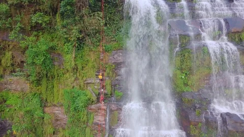 Abseiling by stunning waterfall Video stock 126307813