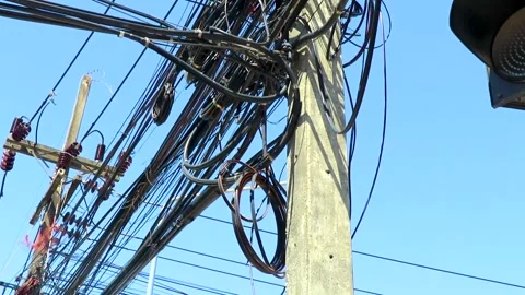 Absolute cable chaos on Thai power pole blue sky Thailand. Stock Footage 327179151