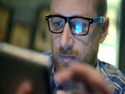 Absorbed man with beard using smartphone, steadycam shot Stock Footage 75907529