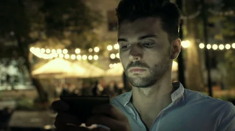 Absorbed man texting message on smartphone at night, steadycam shot Stock-Footage 67852362