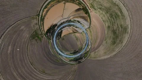 Abstract aerial circular distortion artistic view of rural farmland terrain Stockbeeldmateriaal 345399744
