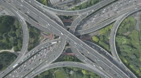 Abstract aerial drone shot of traffic driving over elevated highway in China Stock Footage