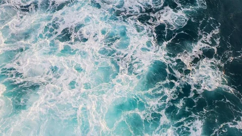 Abstract aerial view of ocean waves crashing on rocky shoreline Stock-Footage 109163425