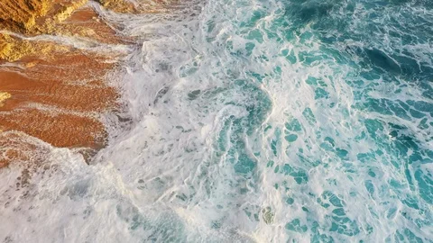 Abstract aerial view of ocean waves crashing on rocky shoreline Stock-Footage 109164796