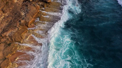 Abstract aerial view of ocean waves crashing on rocky shoreline Stock-Footage 109165720