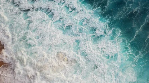 Abstract aerial view of ocean waves crashing on rocky shoreline Stock-Footage 109166817