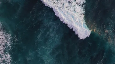 Abstract aerial view of ocean waves crashing on rocky shoreline Stock-Footage 109167212