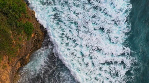Abstract aerial view of ocean waves crashing on rocky shoreline Stock-Footage 109482835