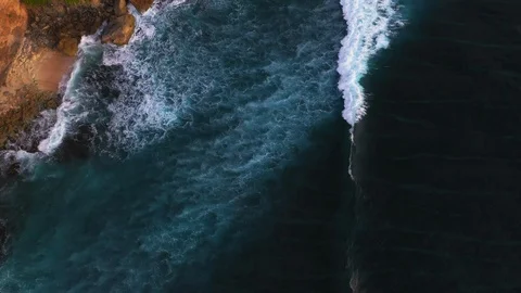 Abstract aerial view of ocean waves crashing on rocky shoreline Stock-Footage 109483105