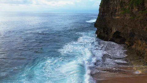 Abstract aerial view of ocean waves crashing on rocky shoreline Stock Footage 109483948