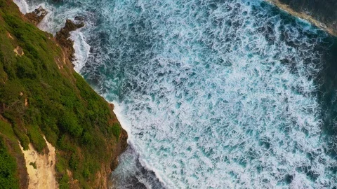 Abstract aerial view of ocean waves crashing on rocky shoreline Stock Footage 109534995