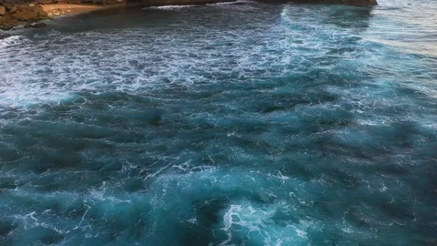 Abstract aerial view of ocean waves crashing on rocky shoreline Stock-Footage 109537204