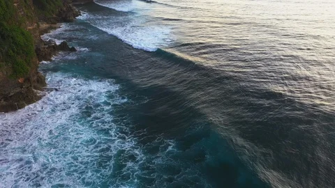 Abstract aerial view of ocean waves crashing on rocky shoreline Stock-Footage 109537454