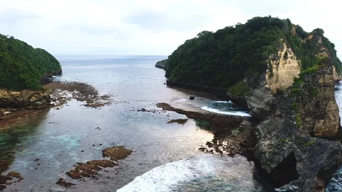 Abstract aerial view of ocean waves crashing on rocky shoreline Stock Footage 111722729