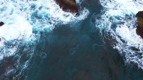 Abstract aerial view of ocean waves crashing on rocky shoreline Stock Footage 111722927