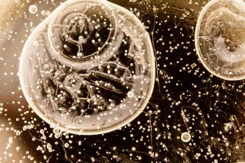 Abstract air bubbles inside the ice macro closeup toned image Stock Photos