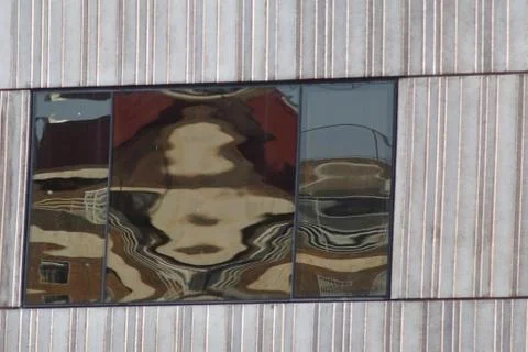 Abstract and artistic reflections in a window of a concrete building Stock Photos