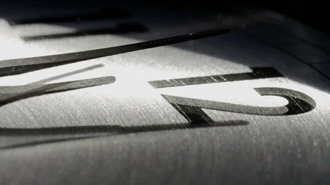 Abstract angle of clock hands moving past 12 on a clock face Stock Footage 74364540