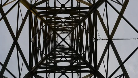 Abstract angle looking upwards at giant power pylon at sub station uk Stock Footage 74245890
