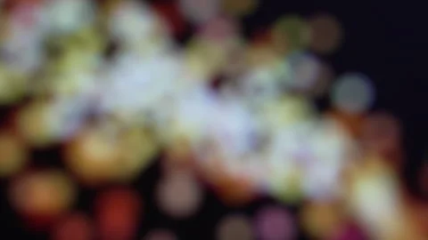 Abstract animation loop of glowing orange and gold bokeh particles flowing from Stock Footage 324719380
