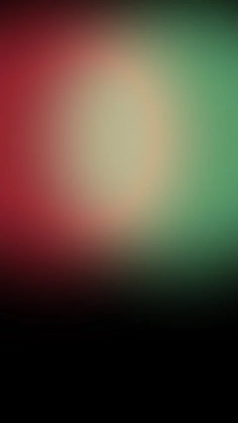 Abstract animation of soft, blurry red and green light leaks shifting on a dark Stock Footage 319610704