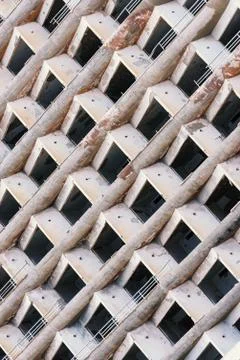 Abstract architectural background with identical windows and balconies in an  Stock Photos