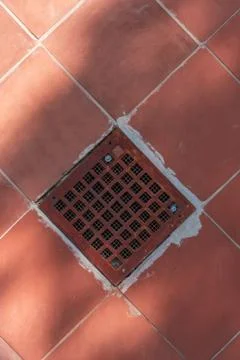 Abstract architectural background with ventilation grill in red tile floor Stock Photos