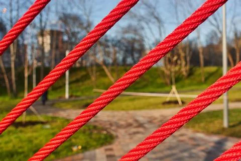 Abstract architectural features, red ropes with Park in the background Stock Photos