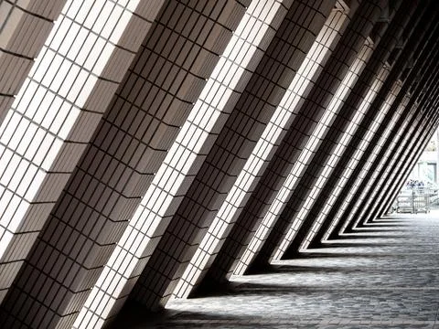 Abstract architectural pattern of repeating geometric columns creating dram.. Stock Photos