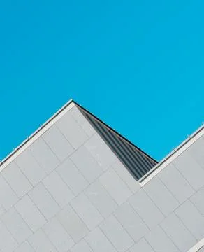 Abstract architectural shape of pyramidal form. Grey and cyan colours Stock Photos