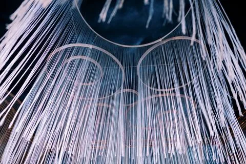 Abstract art installation with hanging strings and circular frames Fotos Stock