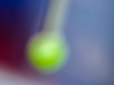 Abstract artwork showcasing a blurred lime orb against gradients of red, wh.. Stock Photos