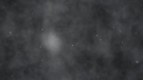 Abstract atmospheric snow particles floating through dark foggy night sky 動画素材 343842505